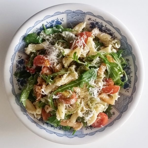 Cured manchego cheese and pasta salad with tomato and rocket